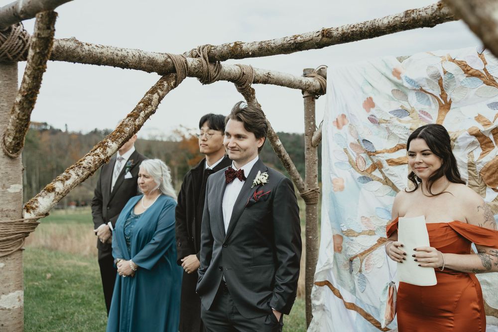 A couple shares intimate moments during a fall outdoor photoshoot wearing teal and black formal attire.