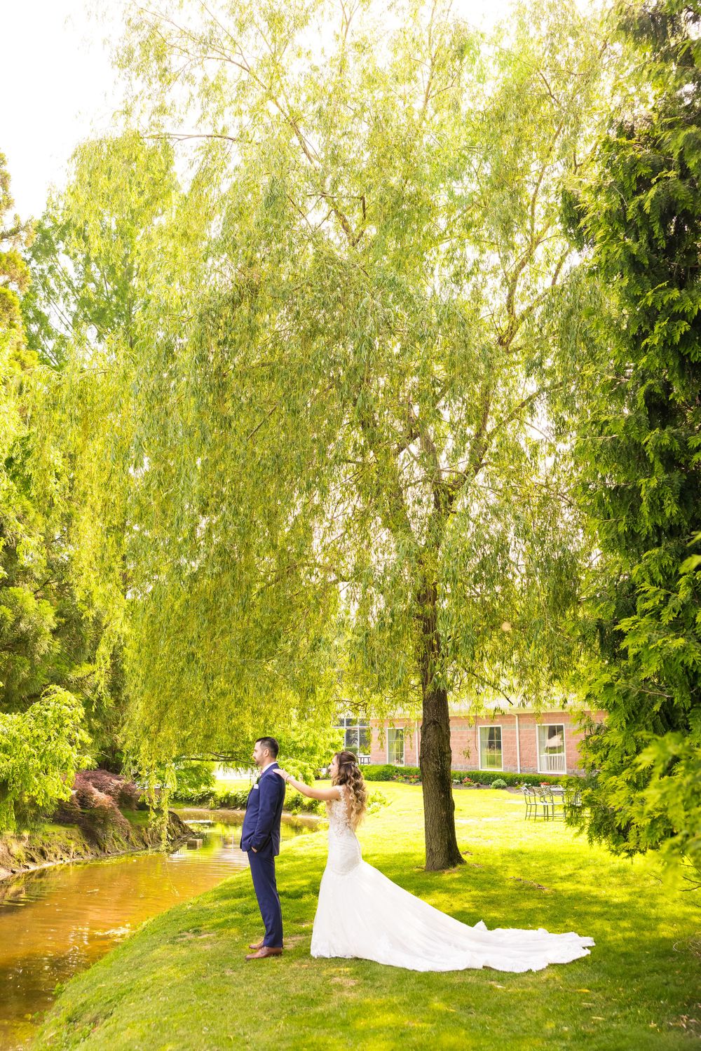 A romantic outdoor wedding photo session in a lush green park with birch trees and natural sunlight.