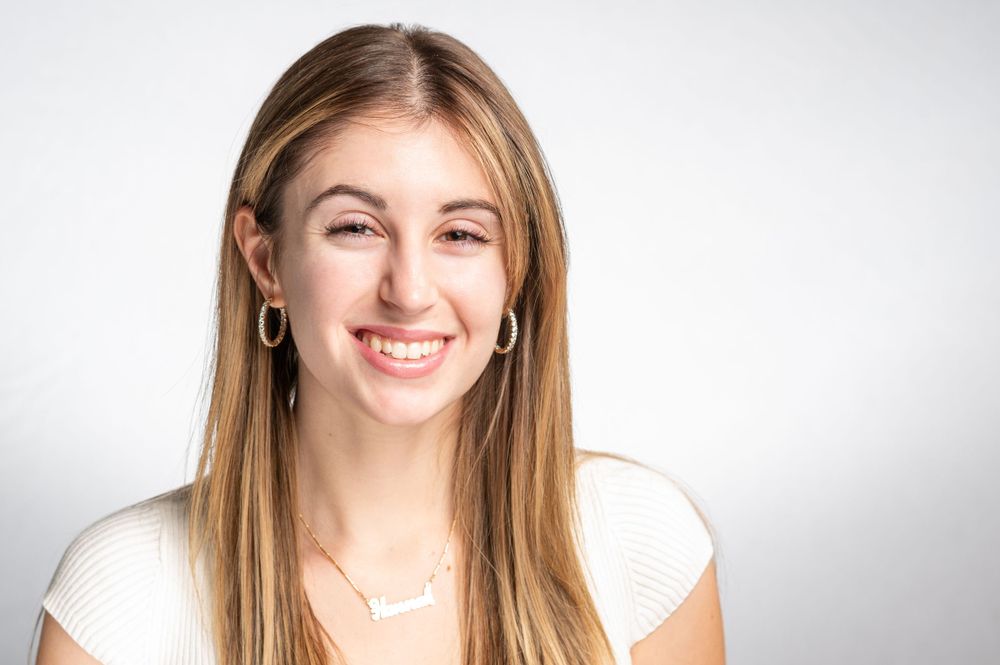 Bright studio headshot with natural lighting capturing a happy expression.