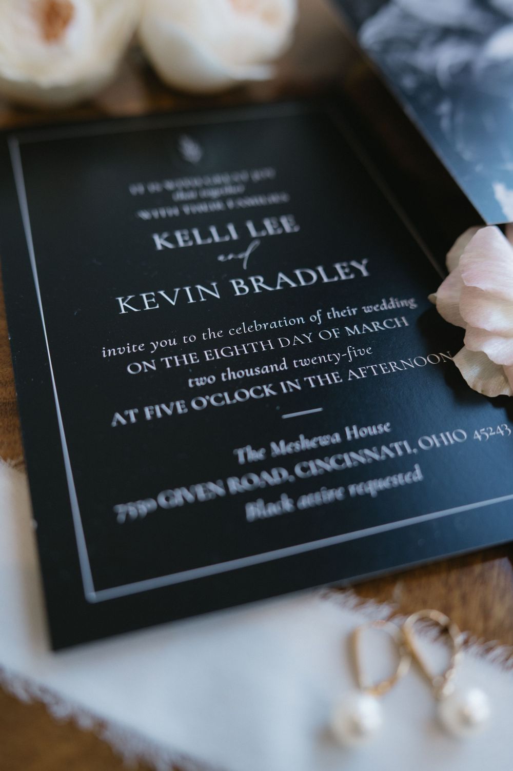 Black wedding invitation with white text for Kelia and Kevin Bradley's celebration.