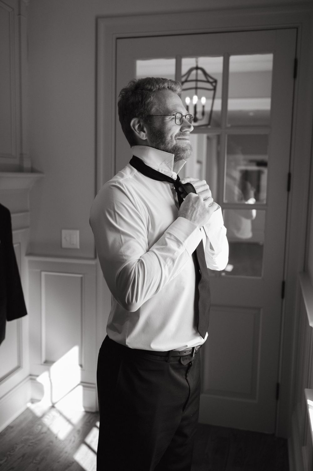 Formal dresswear preparation scene in natural window light.