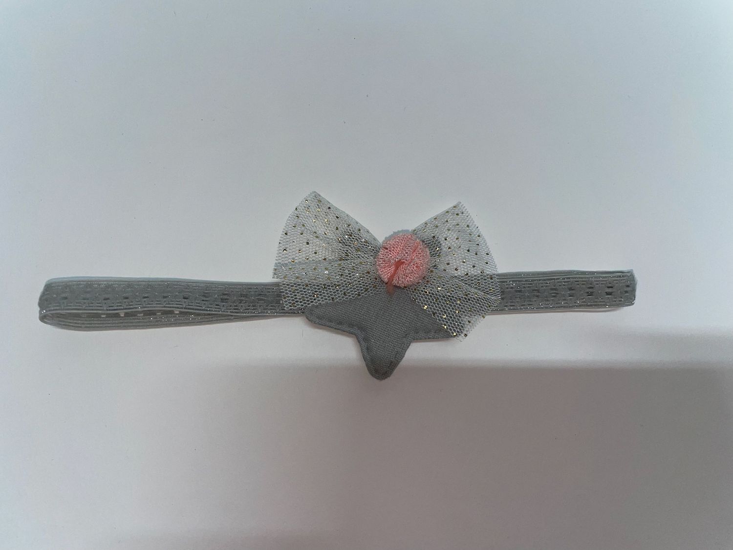 Gray bow tie accessory with delicate details and a subtle sheen.