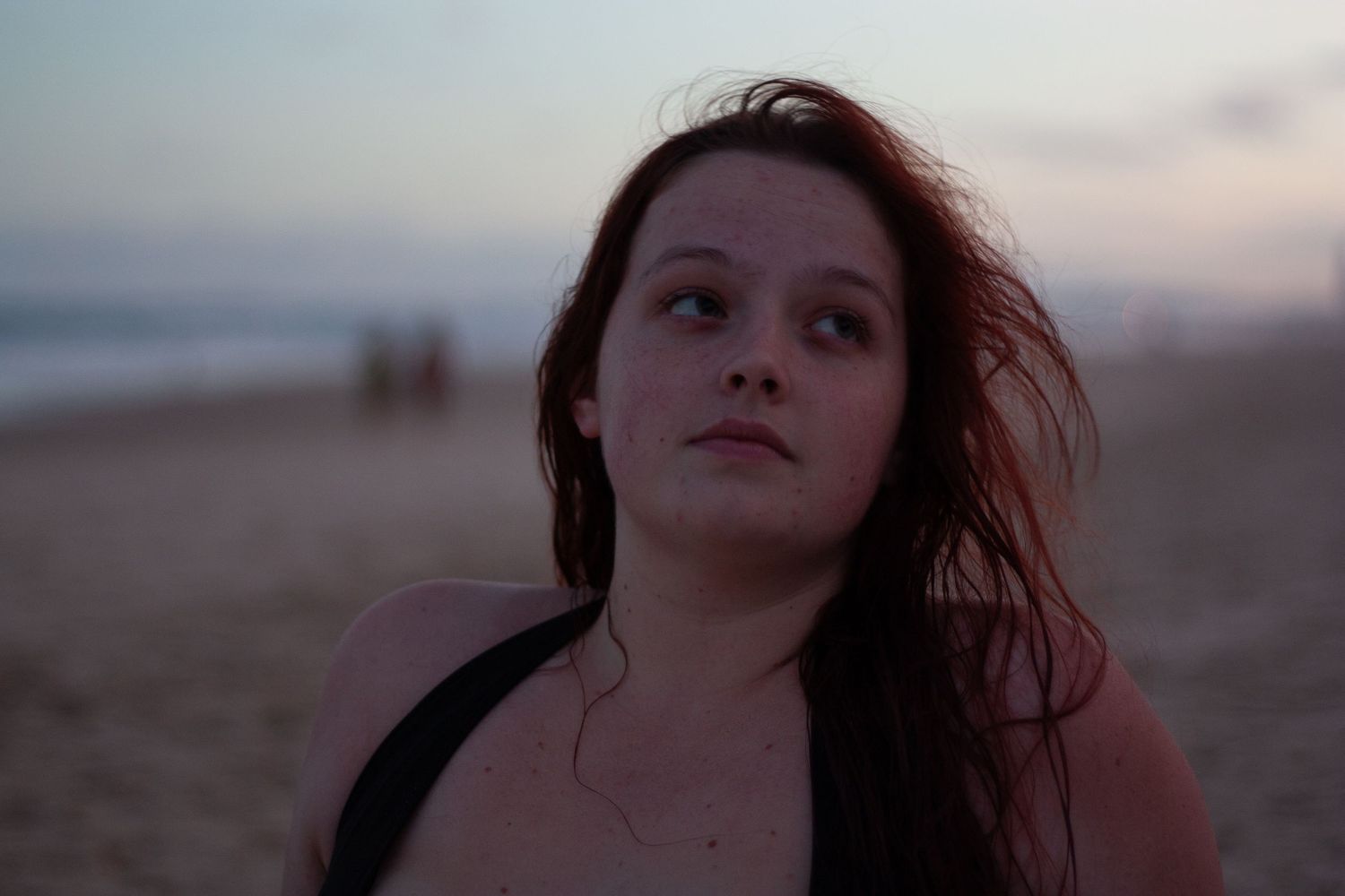 Moody beach portraits at dusk with dramatic lighting and atmosphere.