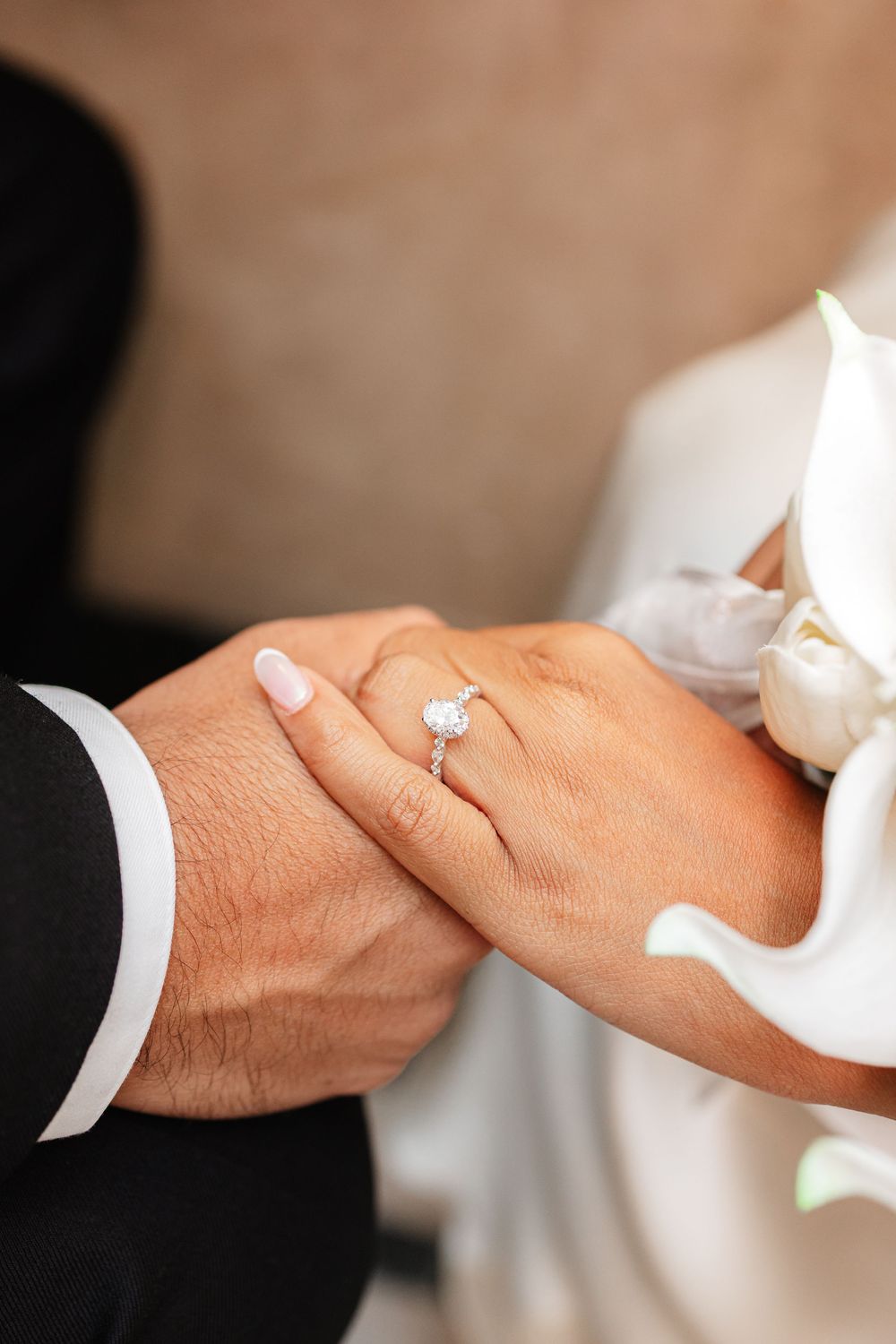 A close-up sequence showing hands exchanging a diamond engagement ring in a romantic proposal moment.