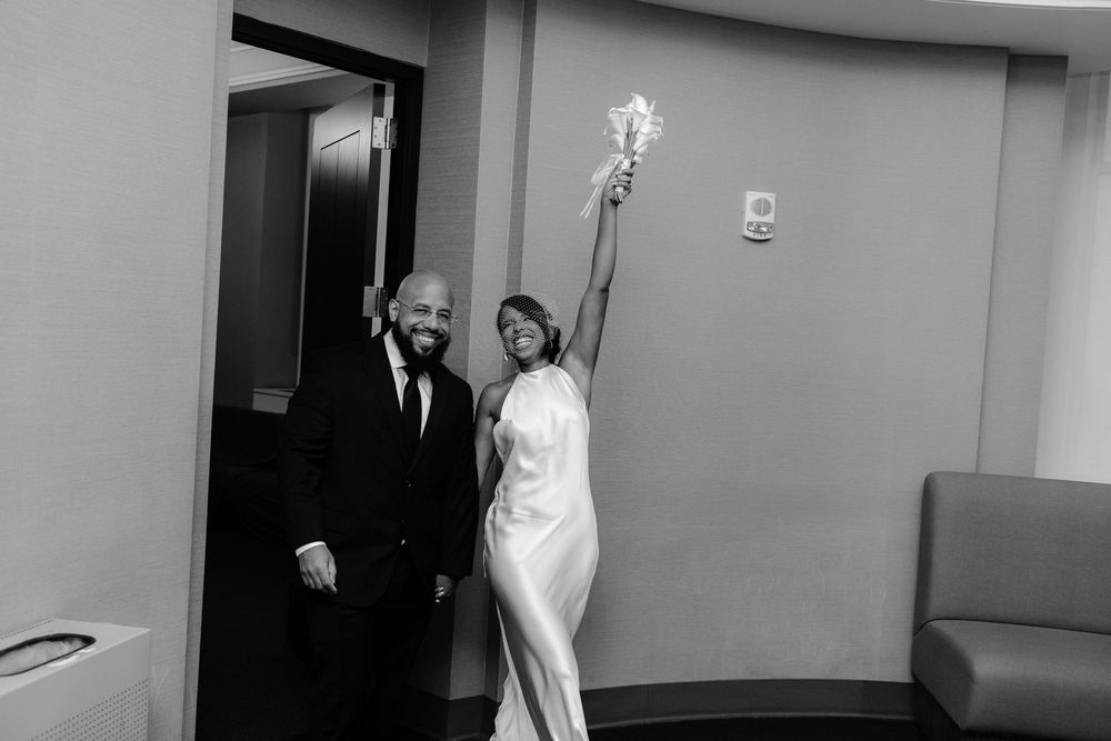 A collection of black and white wedding photos showing candid moments and poses in an indoor venue.