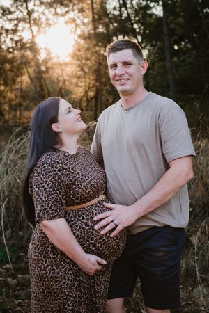 Expectant couple posing lovingly outdoors during their maternity session in Pretoria.
