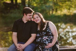 An image of a couple lovingly looking at each other at their maternity shoot.
