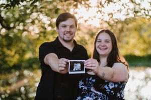 Expectant couple holding their baby ultrasound scan during a maternity photoshoot in Gauteng.