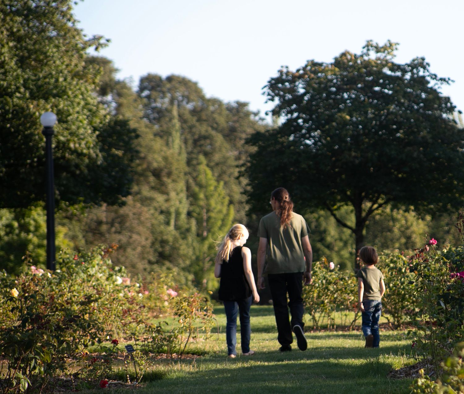 Father and two children walking away