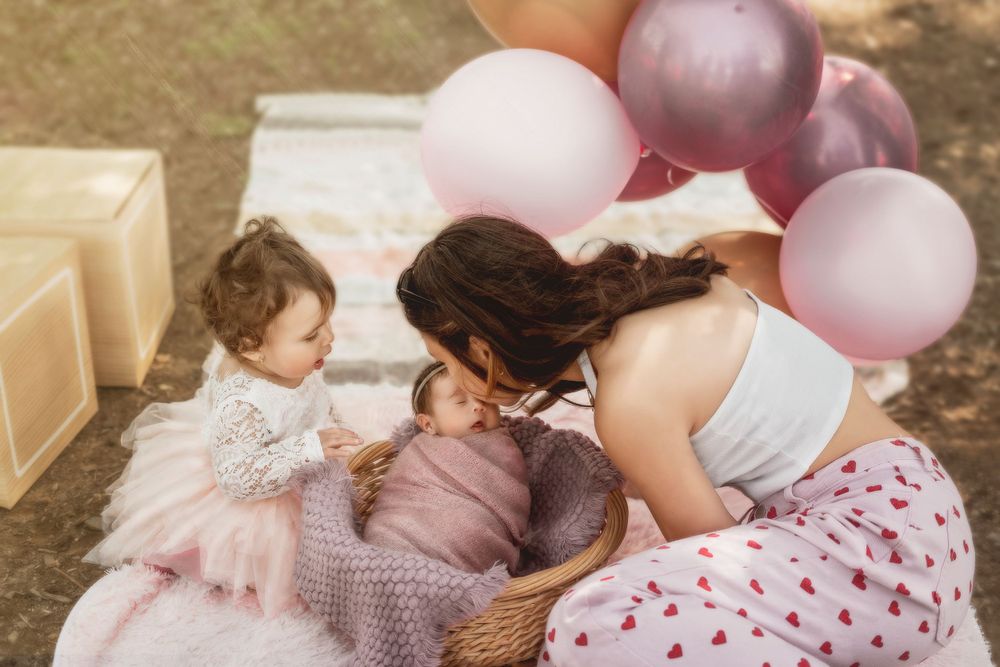 Sweet moment with pink balloons and decorative setup in outdoor setting.