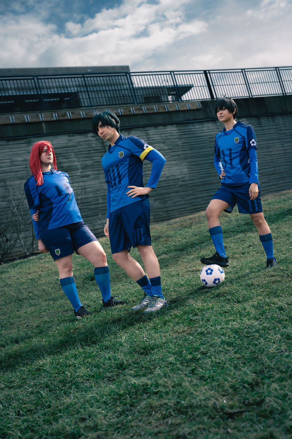 Cosplay portrait of Blue Lock characters standing together in a field.