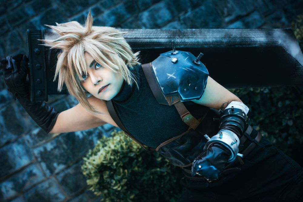 Cloud Strife cosplay from Final Fantasy VII looking upward in a cinematic portrait.