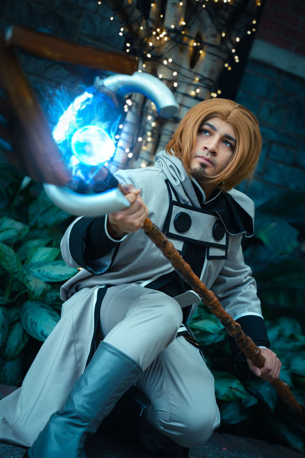 Cosplay portrait of Rudeus Greyrat from Mushoku Tensei casting blue magic.