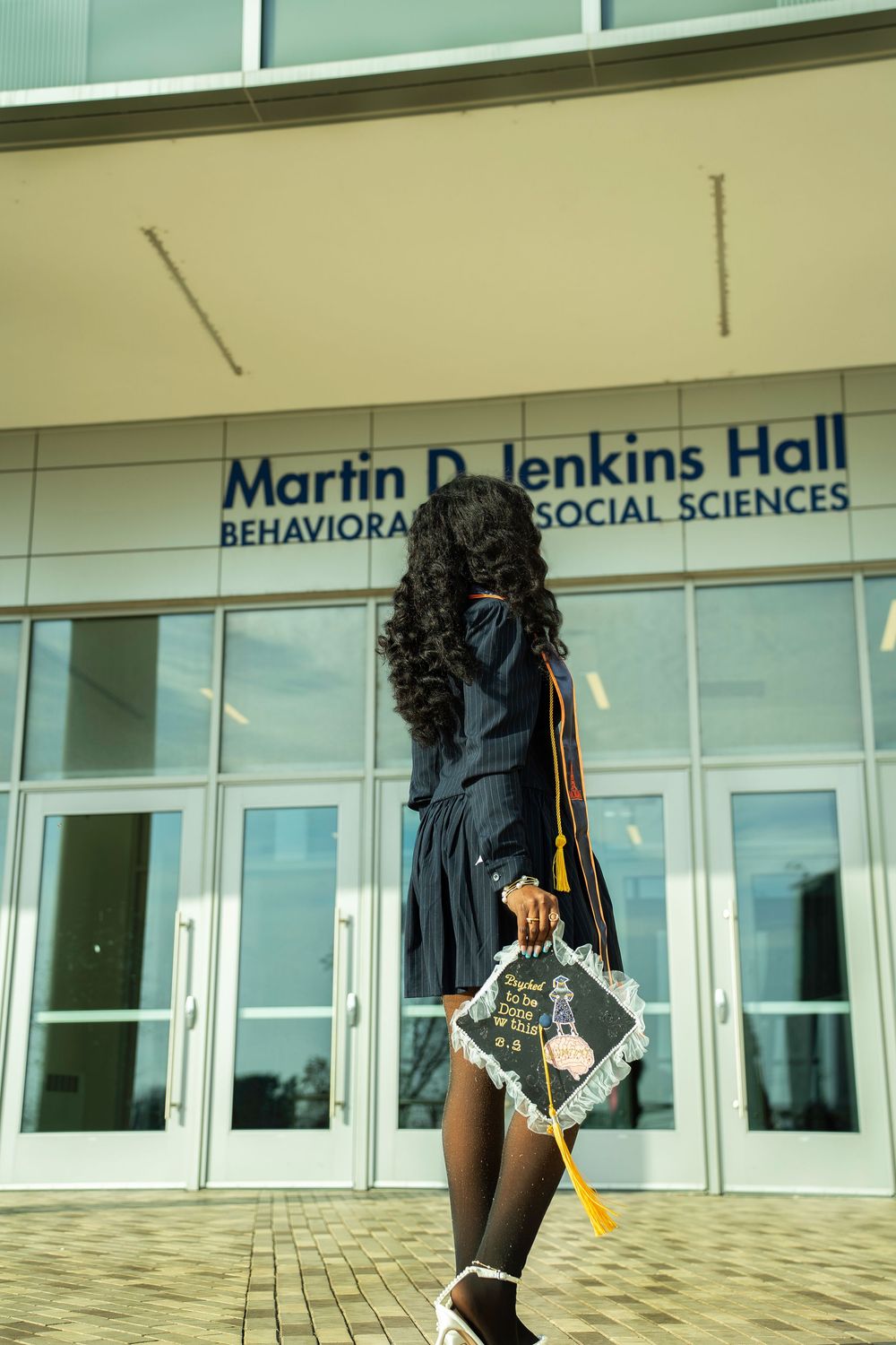 Student walks in front of Martin D. Jenkins Hall at Morgan State University's Behavioral and Social Sciences building.