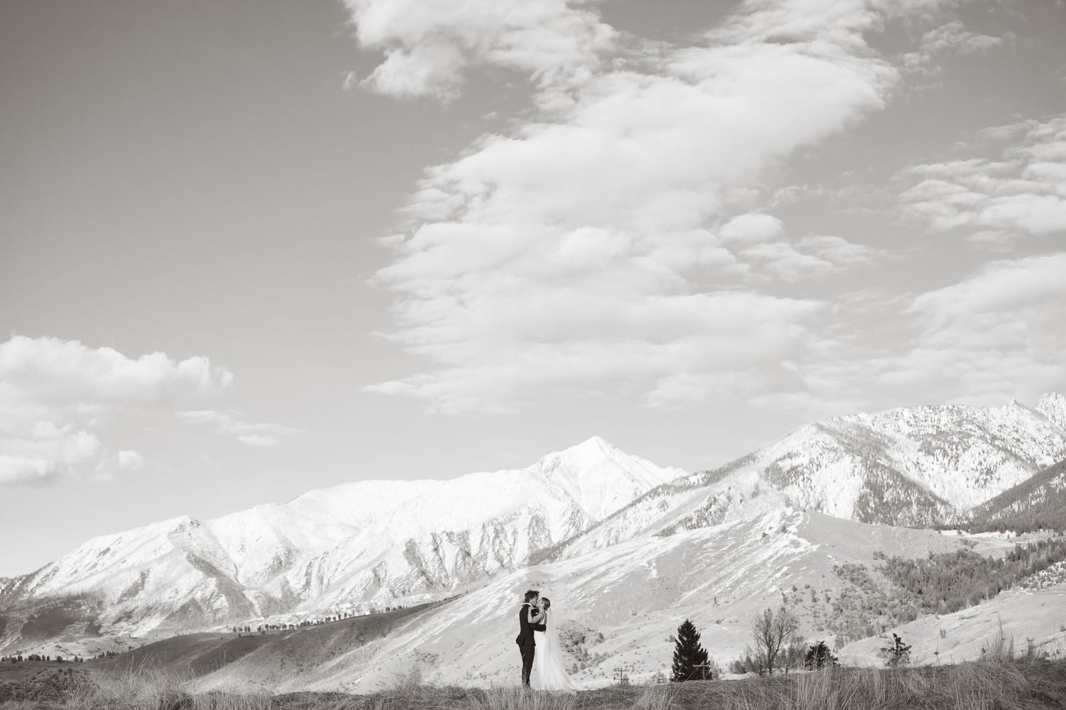Majestic snow-capped mountain peaks create a dramatic backdrop for a wedding celebration.
