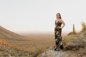 Natural light portrait session in a scenic desert landscape with towering saguaro cacti.