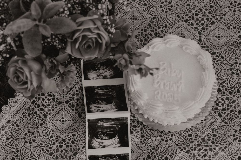 Black and white lace pattern background with floral designs and geometric shapes creates an elegant vintage texture.