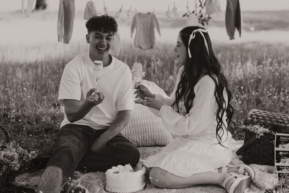 A black and white photo collage shows multiple scenes of people relaxing outdoors in a pastoral setting.