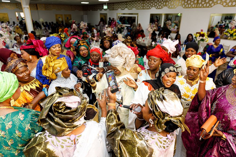 Large group of people in colorful traditional attire gathered at a cultural celebration event.