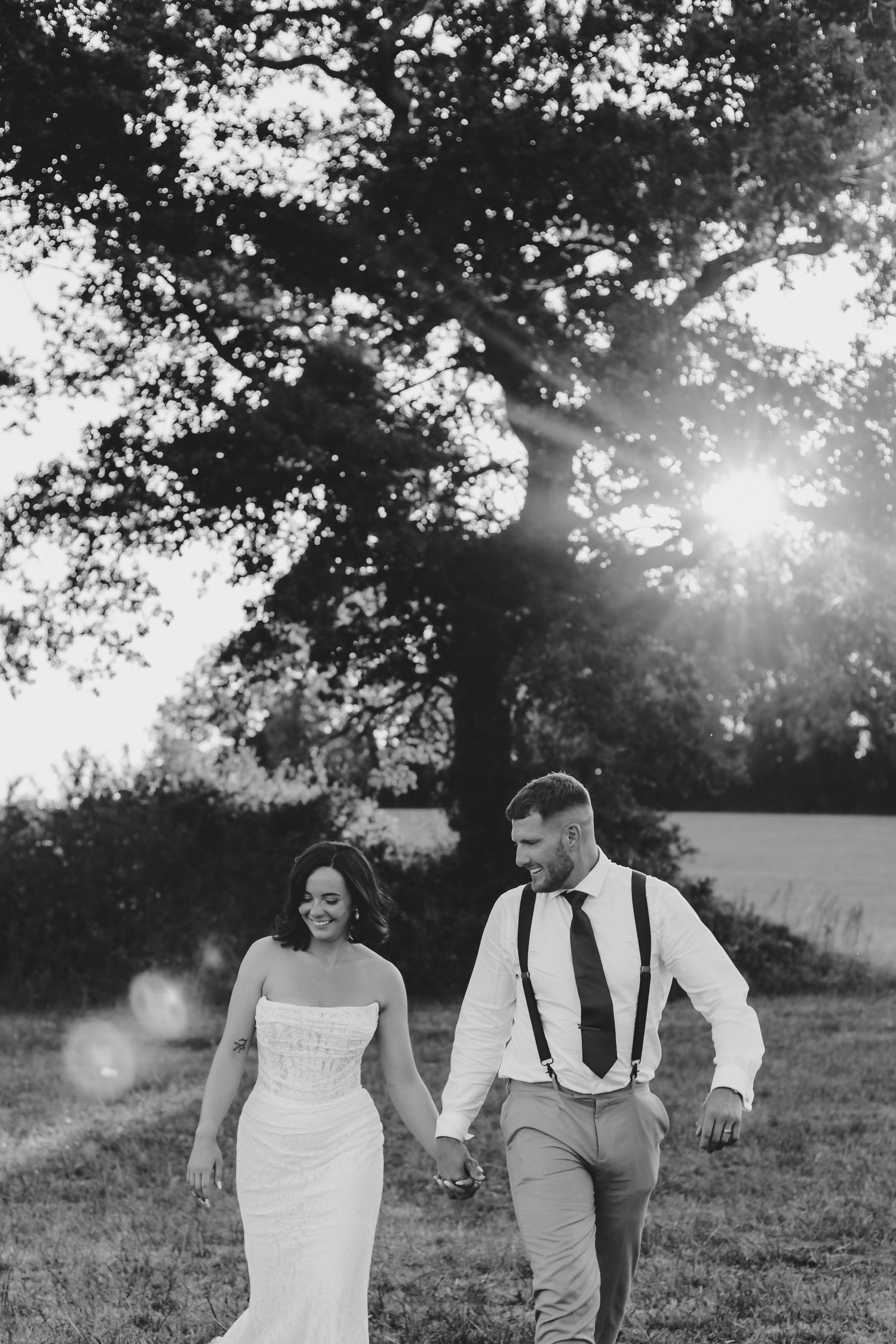 Wedding couple embracing during golden hour in black and white, soft and intimate.