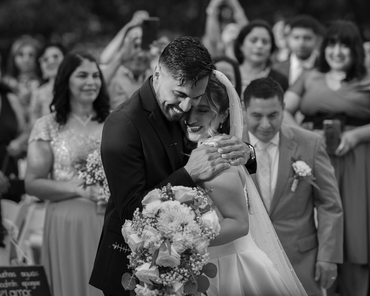 Wedding party celebration with joyful dancing and bouquet toss.