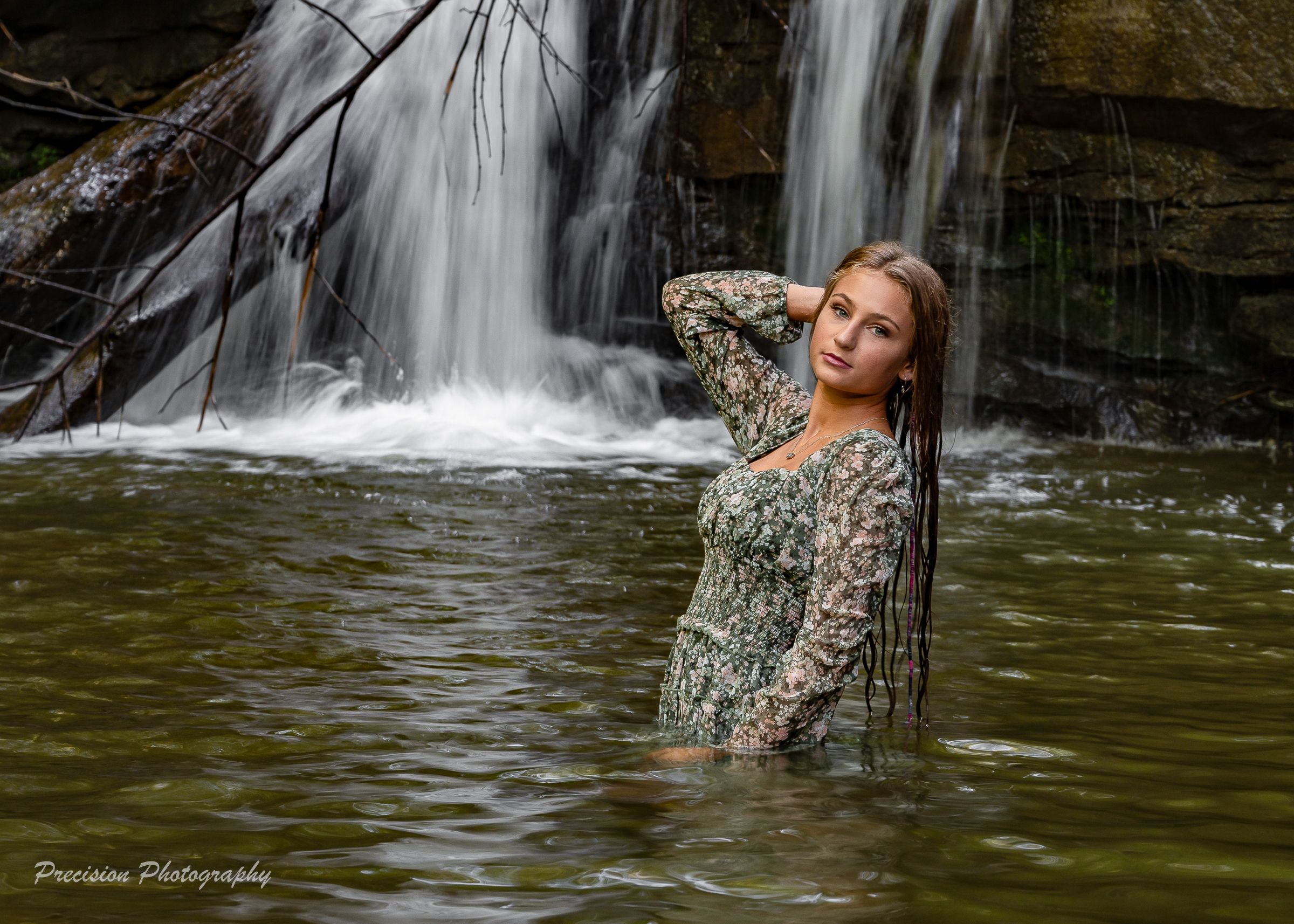 A series of photos showing someone posing in camouflage clothing near a cascading waterfall in a forest setting.