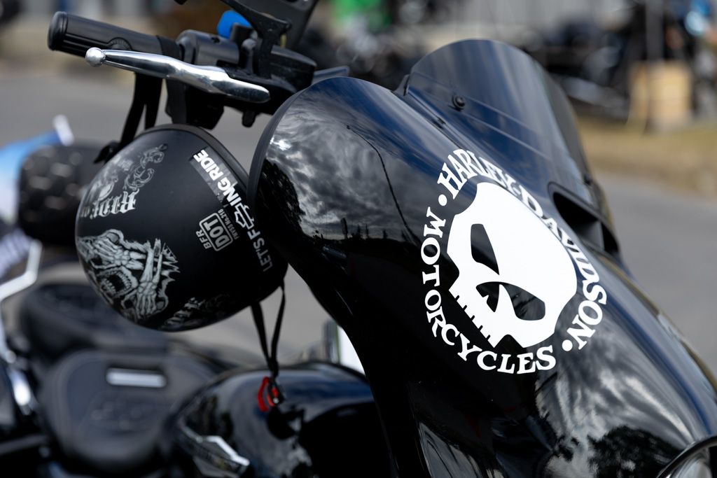 Close-up shots of black and chrome motorcycle parts and logos showing custom details and craftsmanship.
