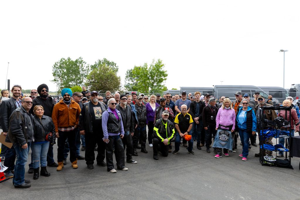 Large crowd of shoppers waiting in line at an outdoor market or event venue.