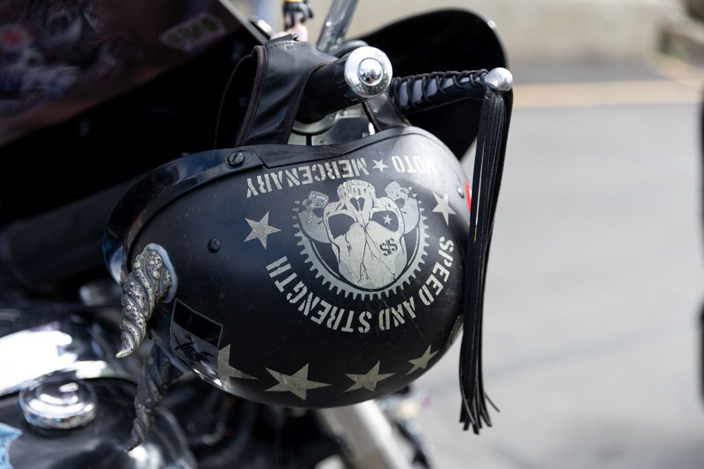 Close-up details of custom motorcycle parts and accessories with black and chrome finishes.
