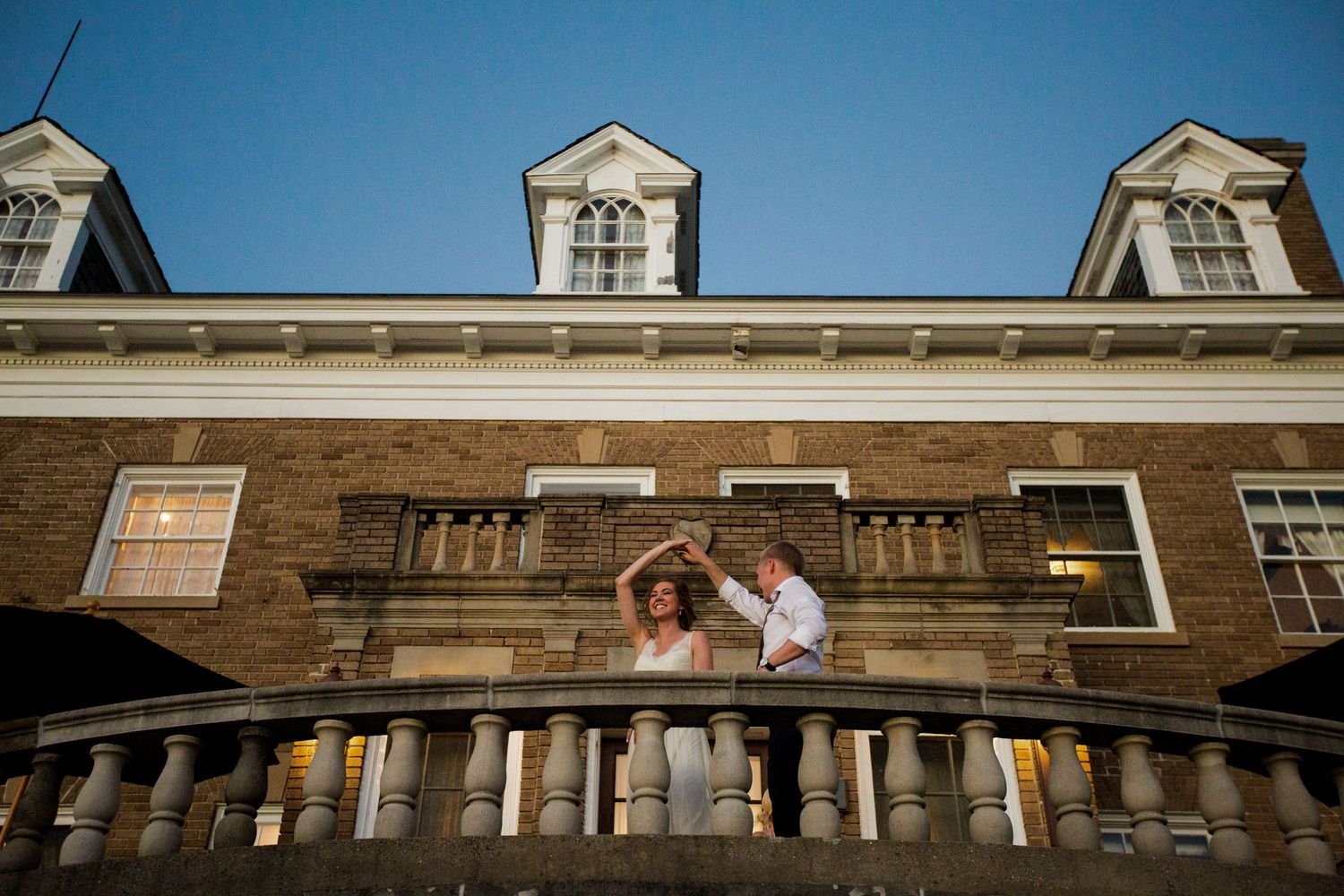 Historic stone building facade with classical architecture creates a dramatic wedding day backdrop.