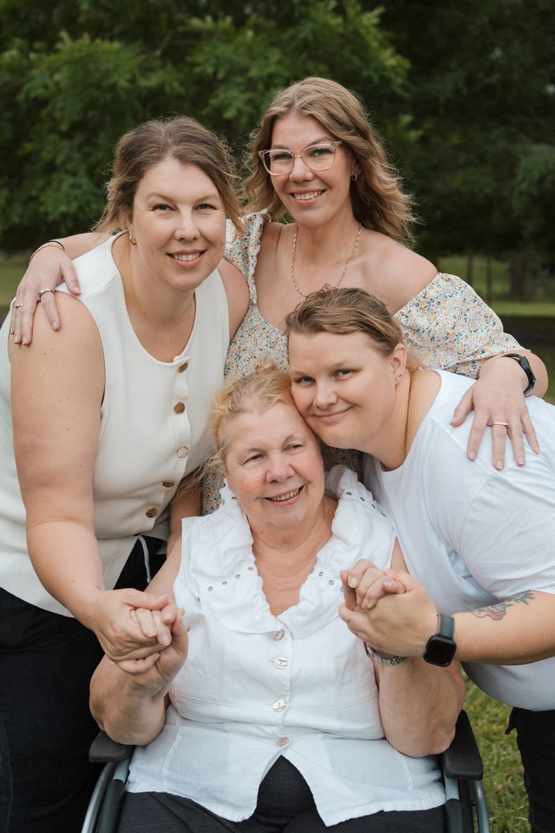 A series of candid family photos showing joyful embraces and laughter while wearing white tops outdoors in Gables family photoshoot