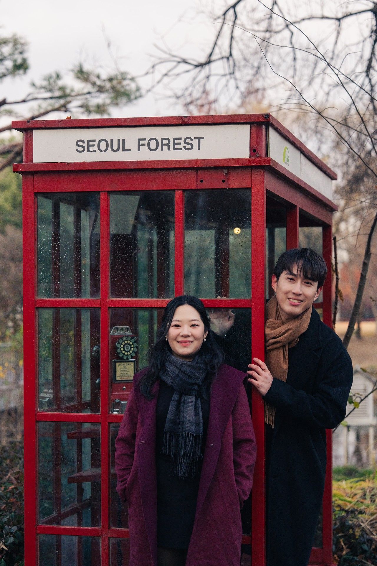 A red phone booth style structure labeled 'Seoul Forest' photographed from multiple angles in a park setting.