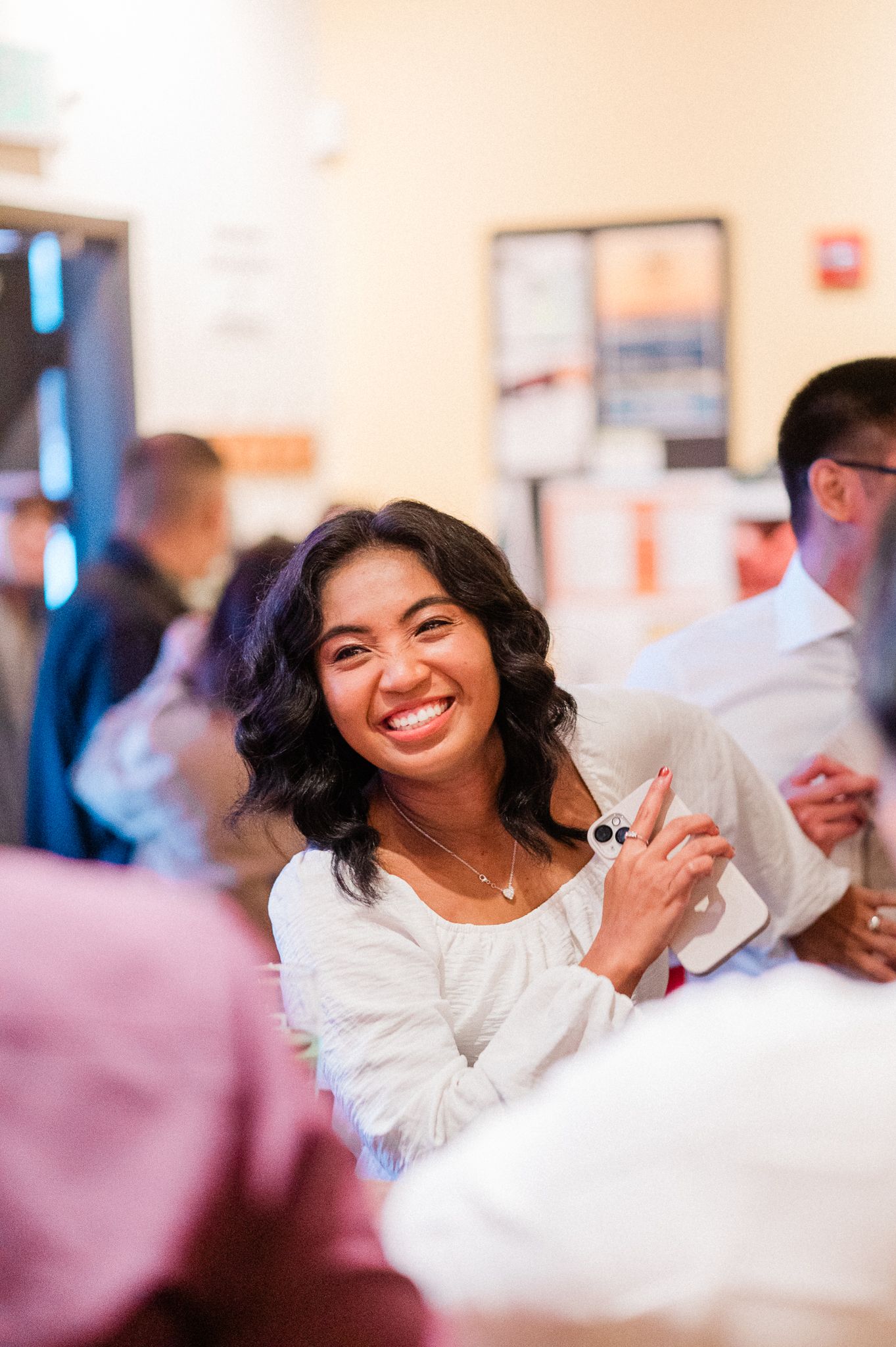 A bride laughs joyfully during a celebratory event.