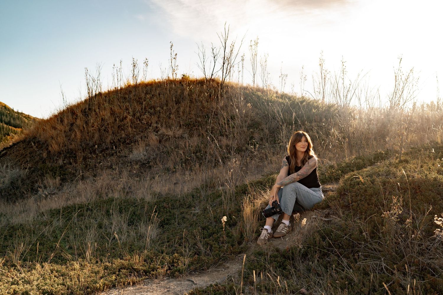 Scenic mountain views with golden sunlight and tall grass.