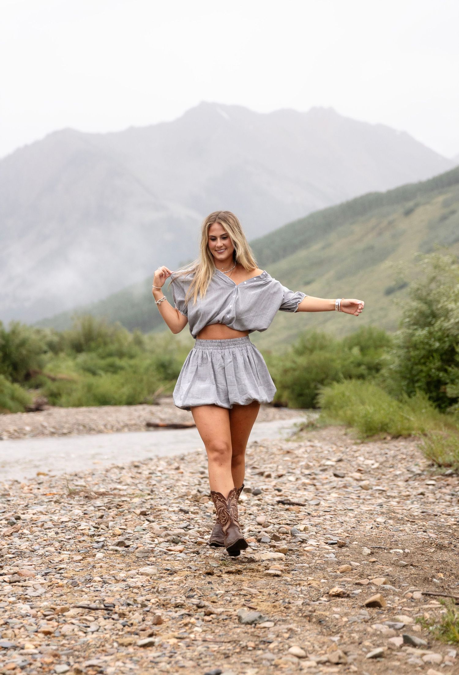 A cute girl walking during her senior photoshoot in Aspen, CO