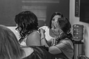 two people having an intimate moment during hair and makeup preparations. Dallas Fort Worth Wedding getting ready. North Texas Wedding