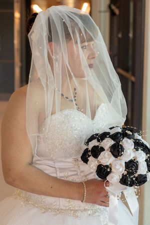 Bridal details featuring a white wedding dress and black and white floral bouquet. Denton County Courthouse Wedding