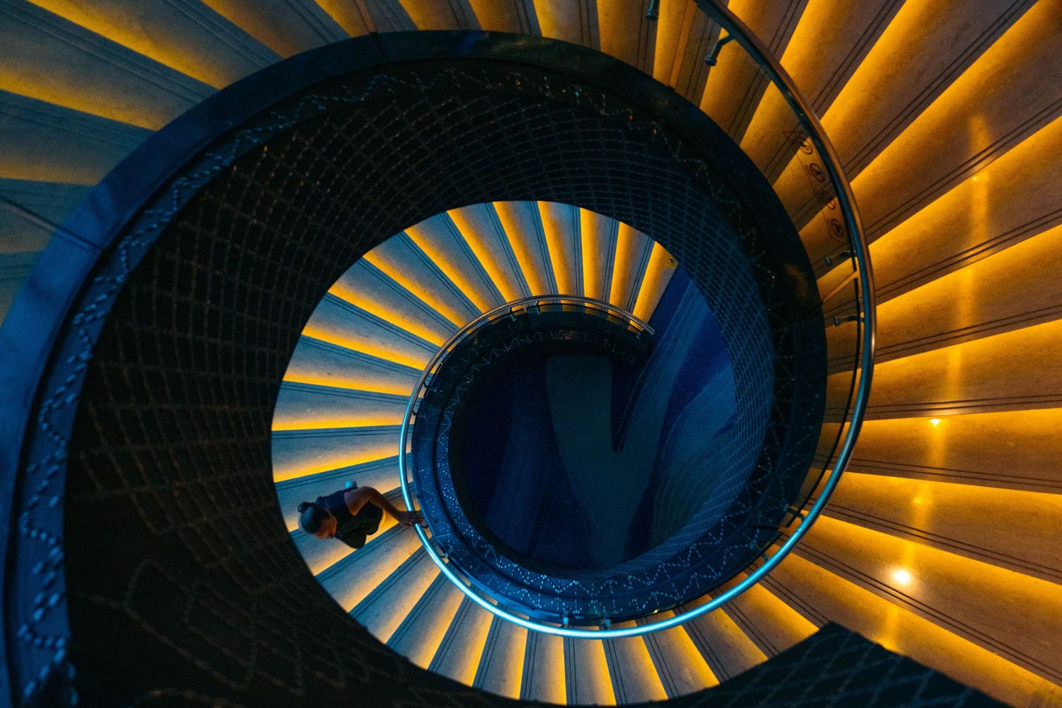 Spiral staircase in blue and orange lighting