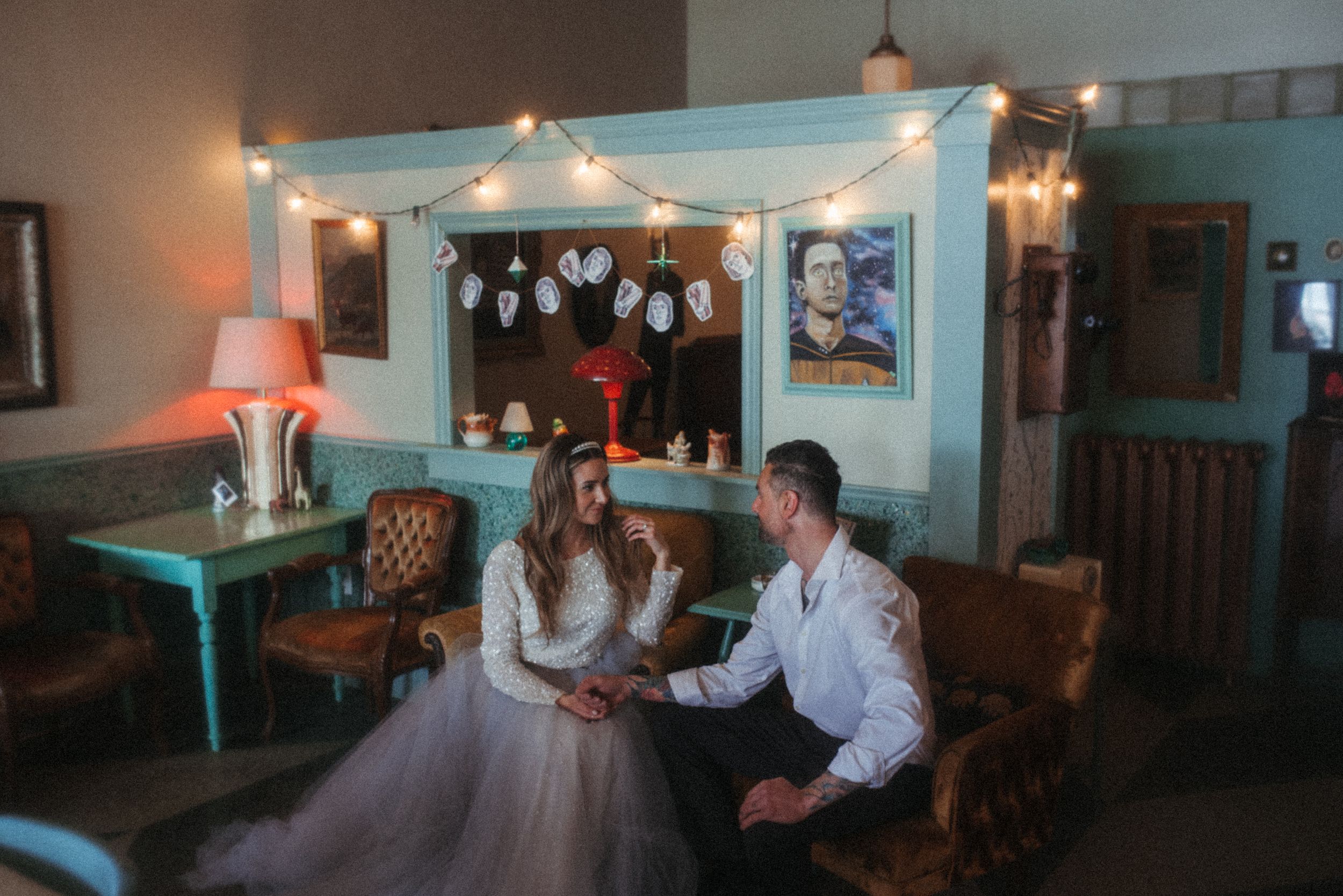 Interior of retro diner decorated with string lights and vintage furnishings.