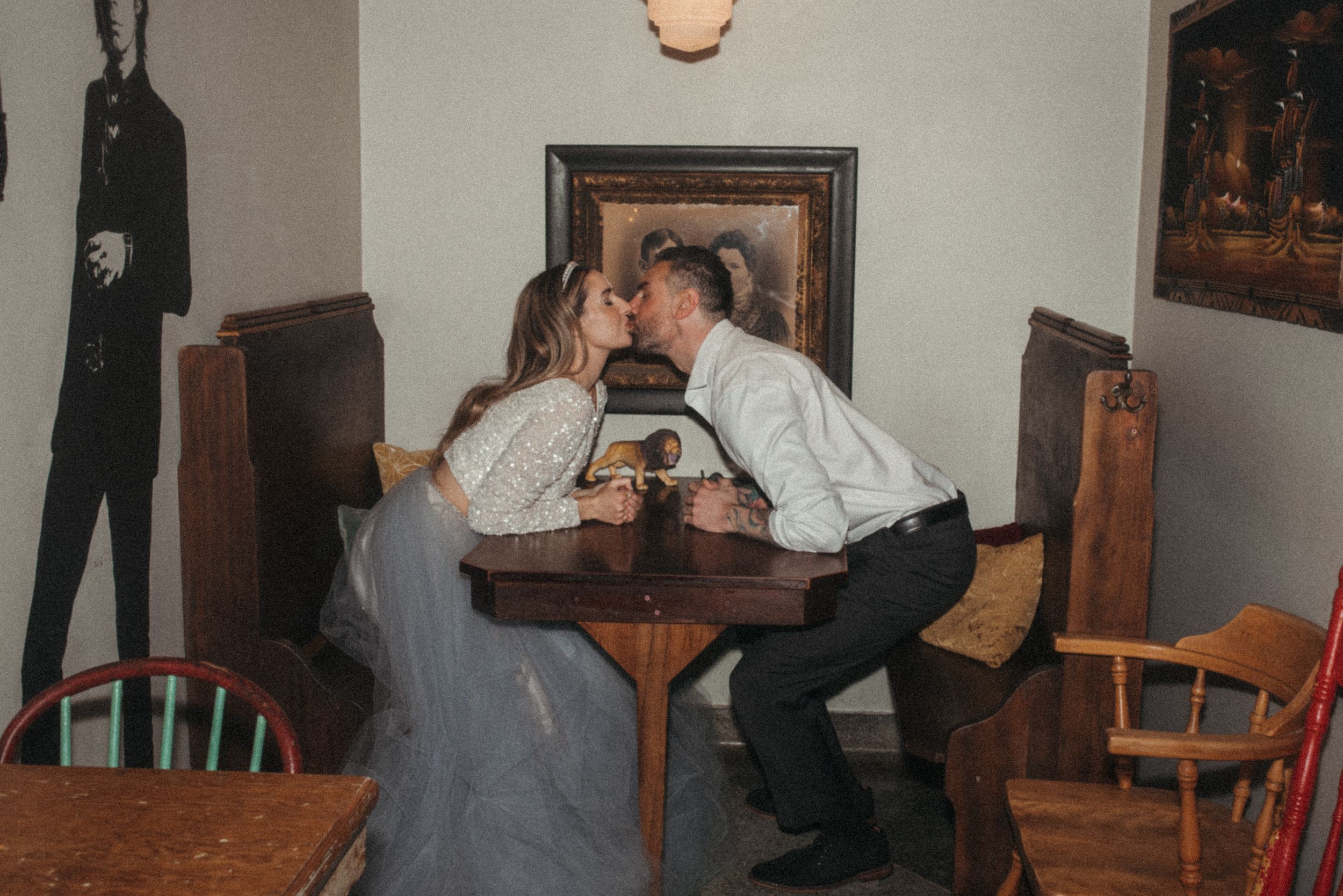 A romantic moment shared over drinks at a vintage diner table.