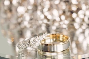 Close-up of wedding rings with sparkly bokeh background.