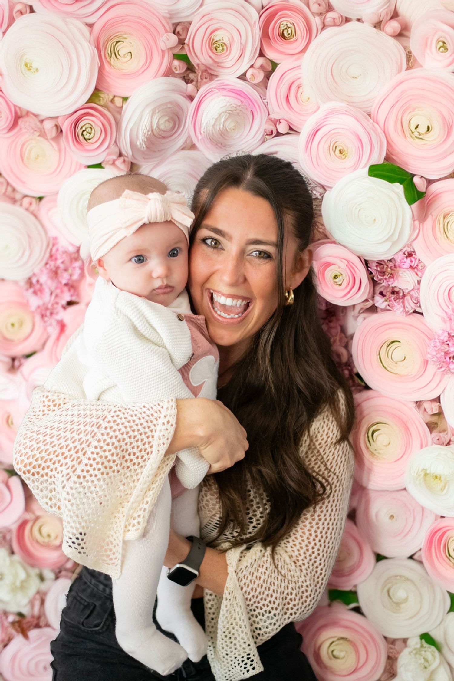 A happy moment captured against a backdrop of pink and white ranunculus flowers in full bloom.
