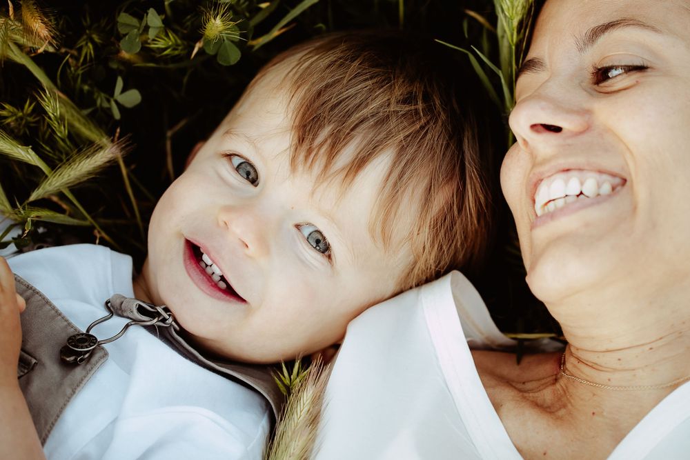 Candid lifestyle portraits showing joyful expressions against natural backdrop.
