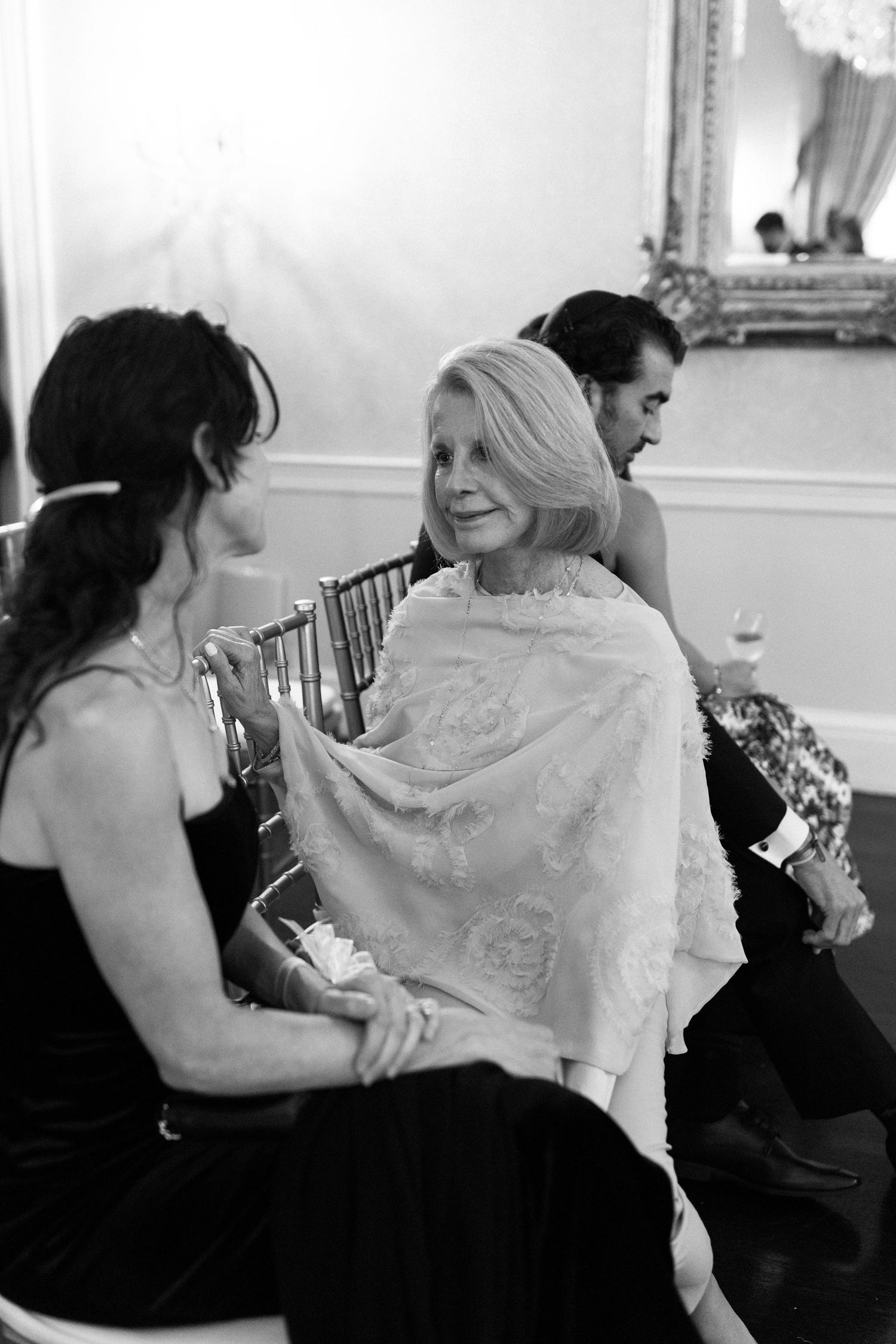 Intimate black and white candid moment during wedding preparations.