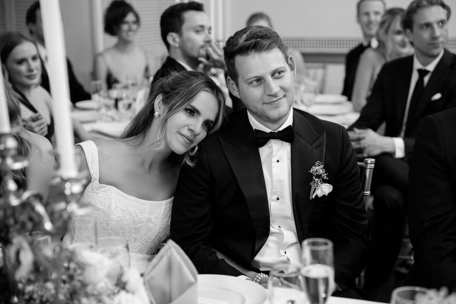 Intimate reception moment captured in black and white during wedding dinner.