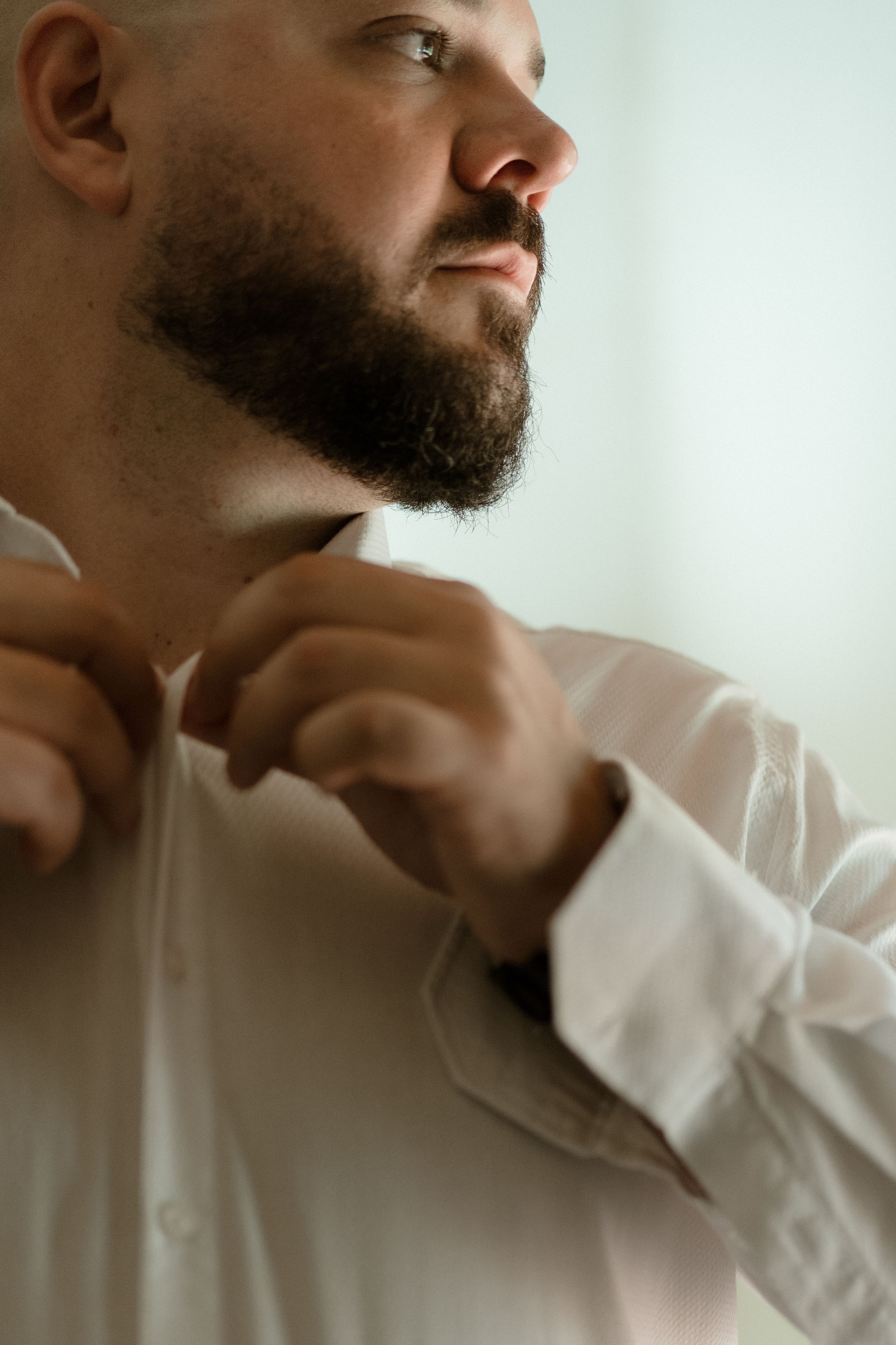Close-up profile shots showing a bearded person in white clothing.