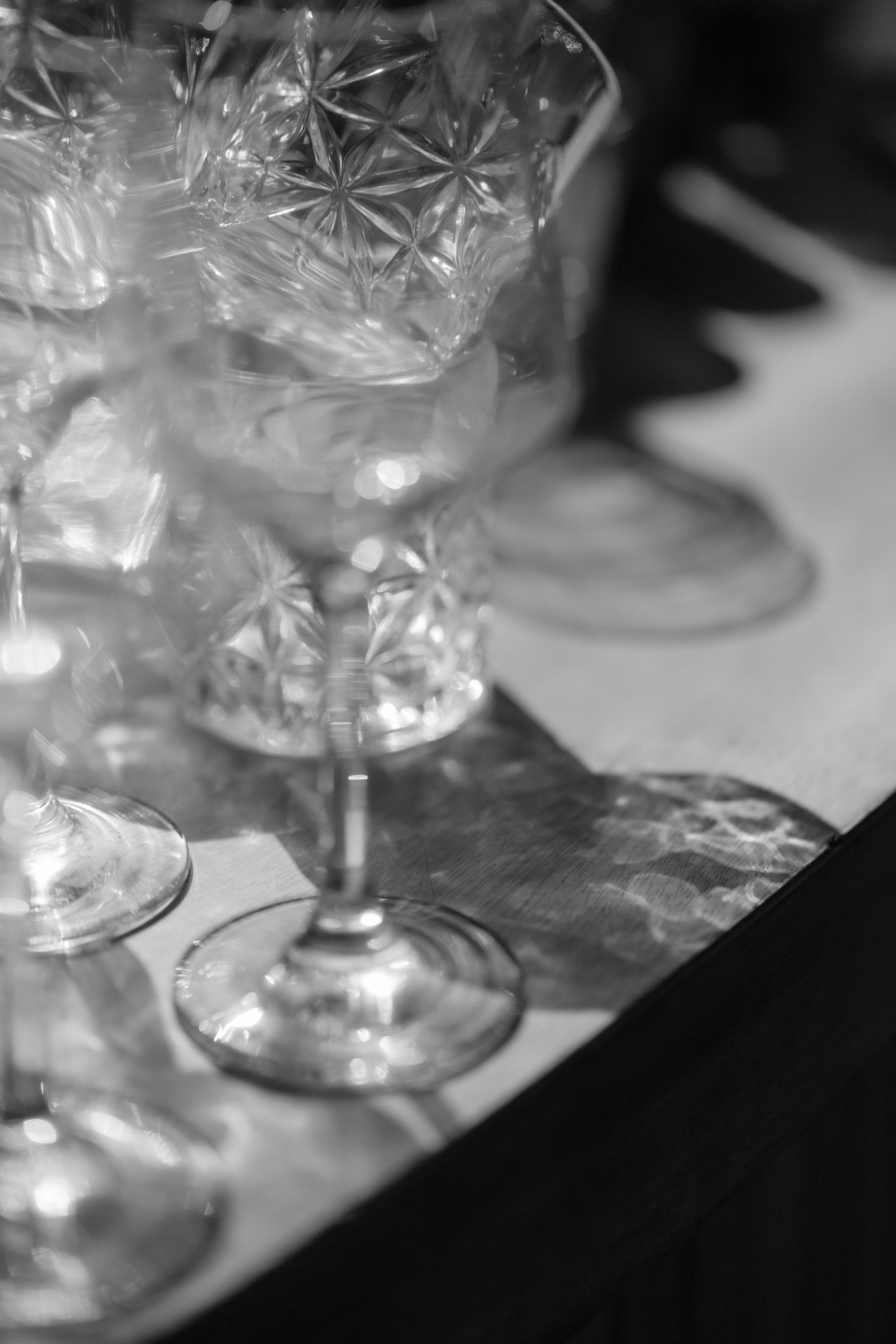 Close-up detail shot of crystal glasses on a table setting.