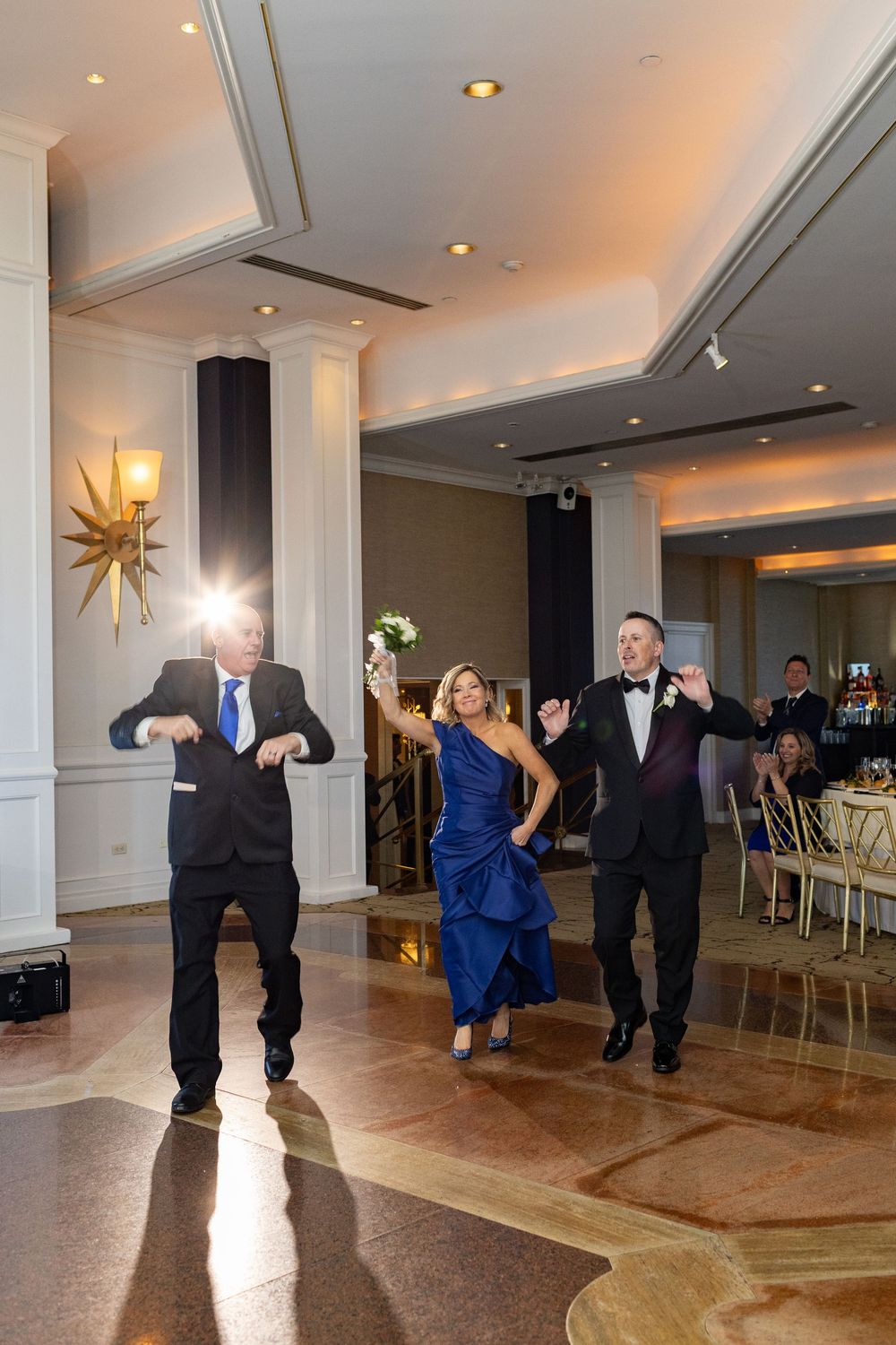 Parents of the bride dancing into the reception ballroom at Glen Island Harbour Club wedding venue in Westchester County.