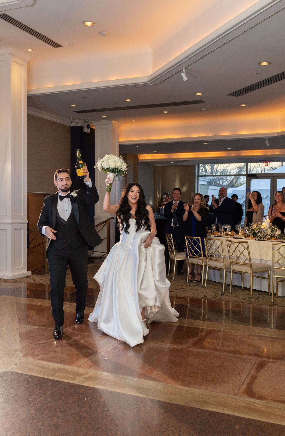 Bride and groom making their grand entrance into the reception ballroom at Glen Island Harbour Club wedding venue.