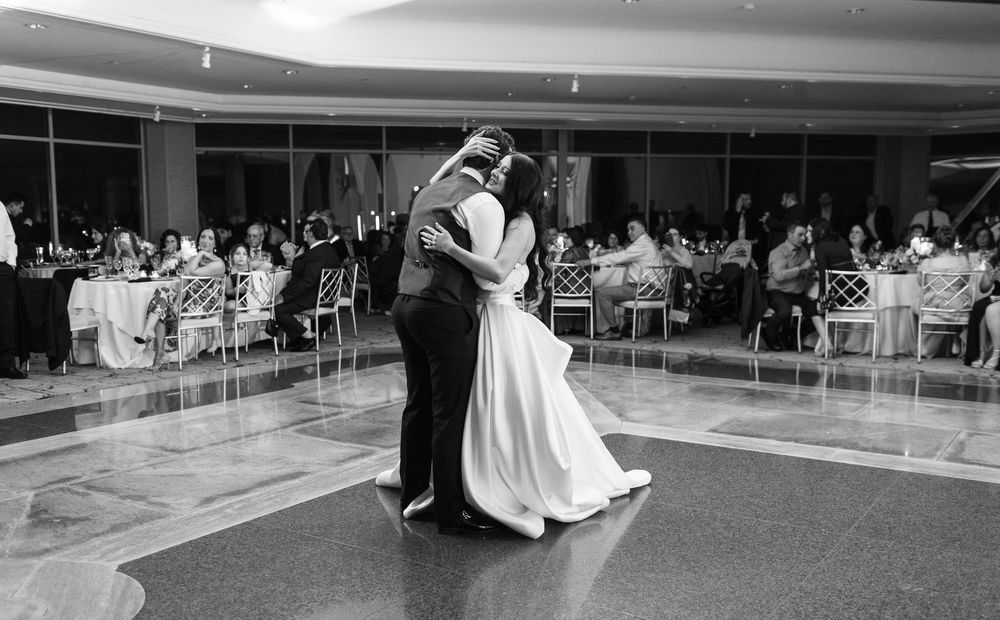 Bride and groom sharing an emotional first dance surrounded by family and friends during a Glen Island Harbour Club wedding.